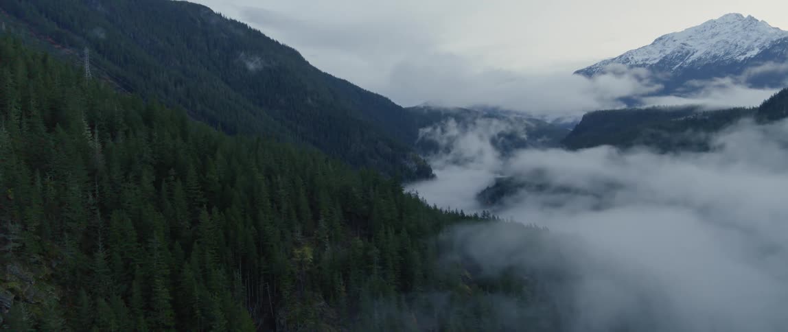 Low lying clouds fill valley between mountains