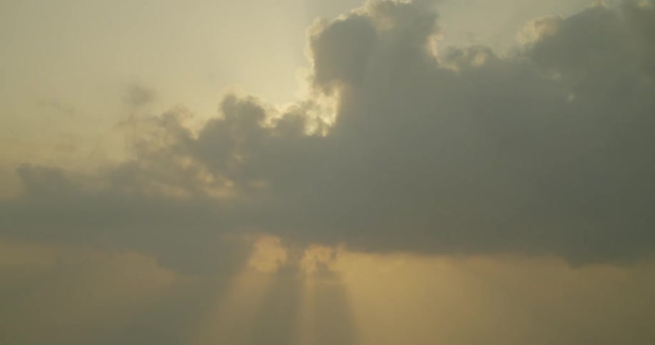 Sunlight peaks through dense clouds in the sky