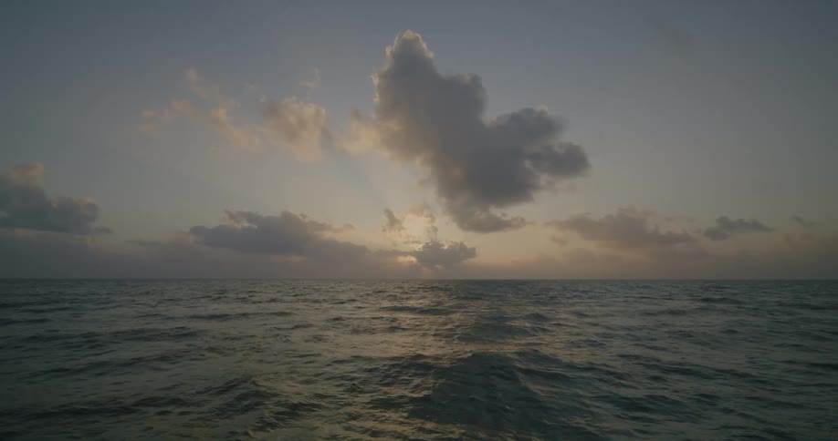 A view of an ocean with waves on it