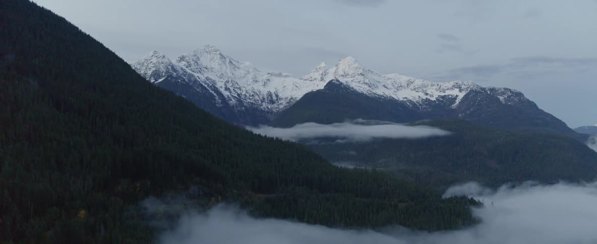 Foggy and snowy mountain range
