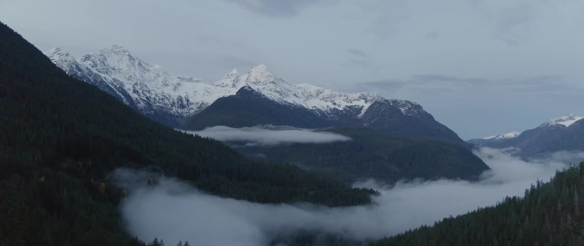 Snow capped mountains on a cloudy day