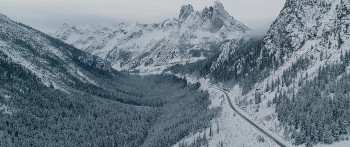 Winding road sits between the snowy mountains