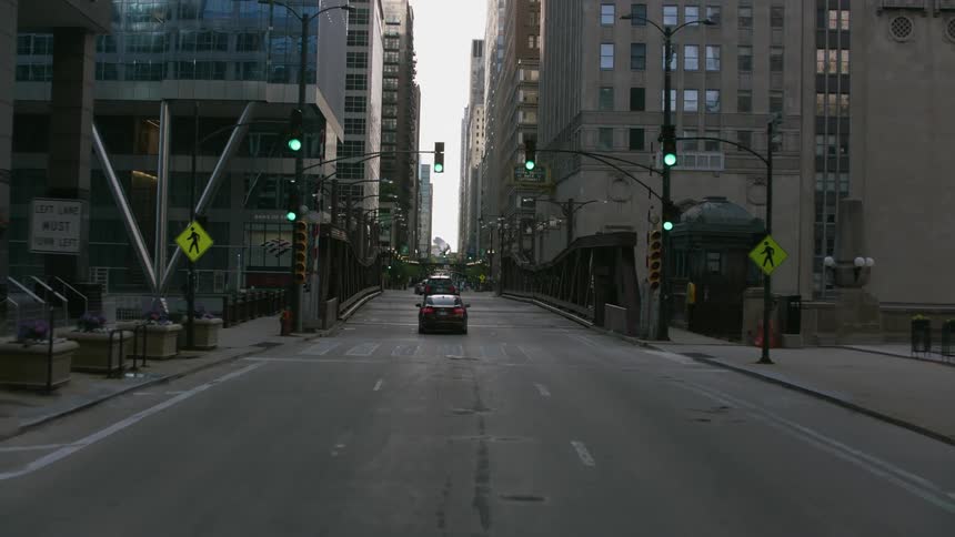 Cars drive on the road through the city