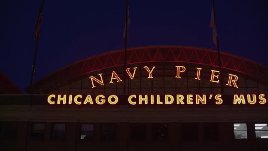 The letters in neon lights shine outside of the navy pier chicago childrens museum
