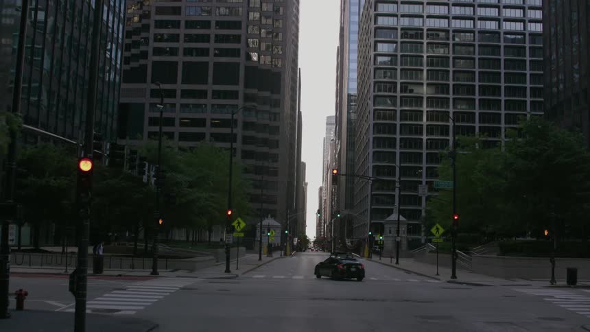 A view approaching and revealing downtown skyscrapers from an empty Chicago city street in the morning