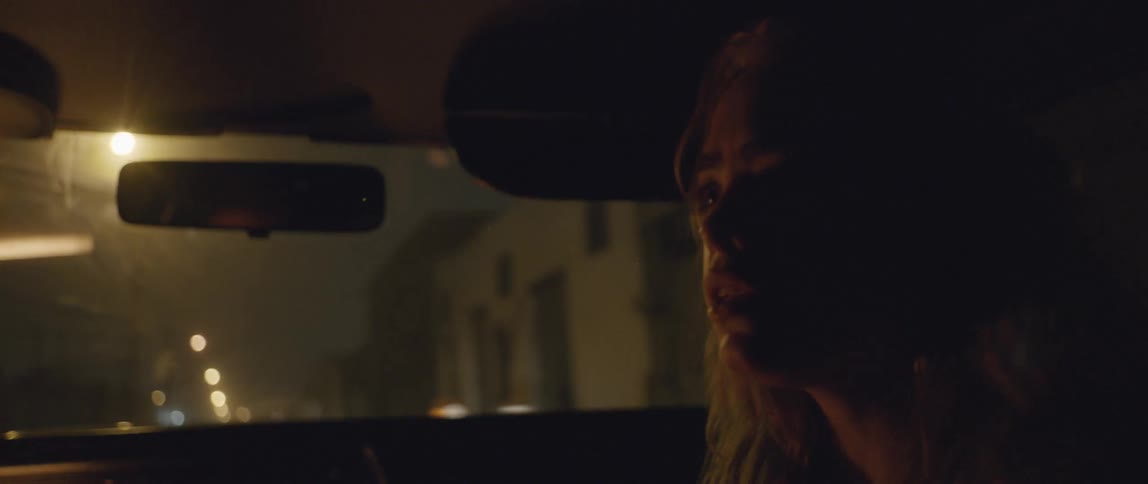 A man and woman argue in a car