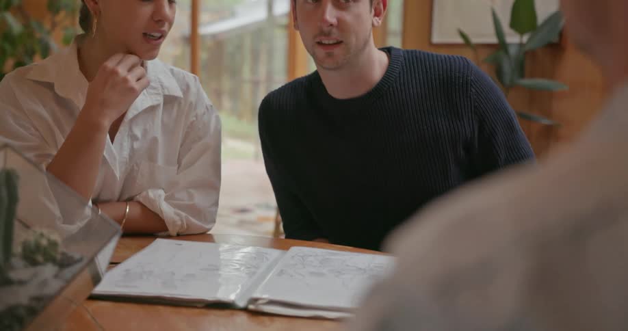 People sit together at a table talking