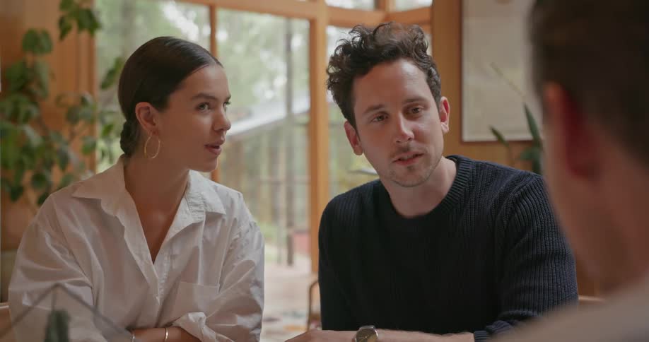 Three people chat while indoors