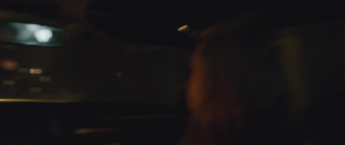 Two people talking in a moving car