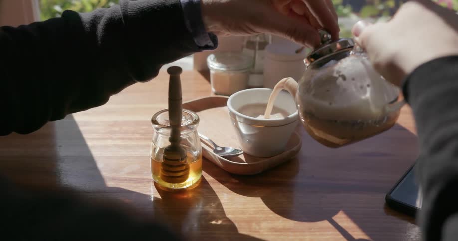 A man pours liquid from a kettle