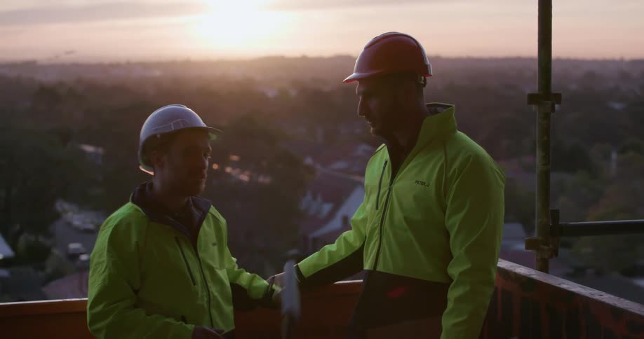 Two construction workers have a conversation