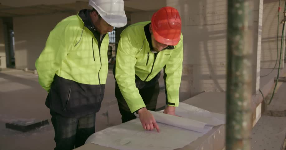 Two men discussing building plans
