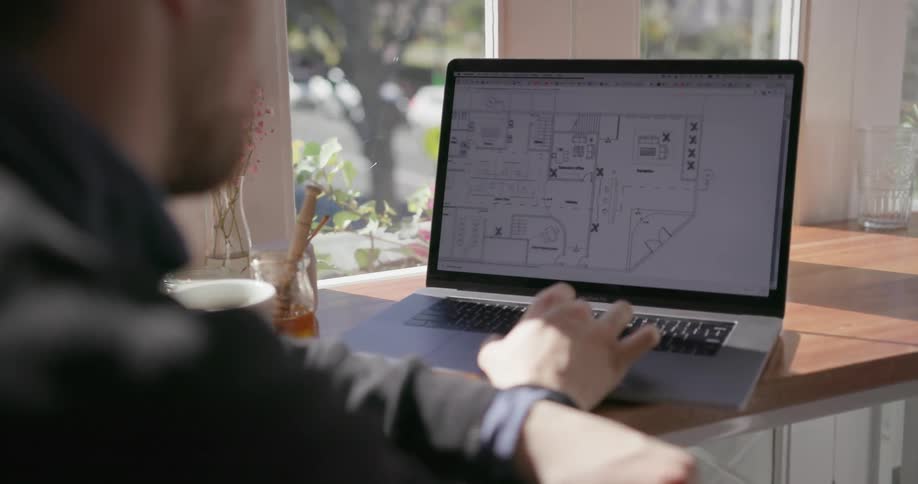 Someone is looking at floor plans on their laptop
