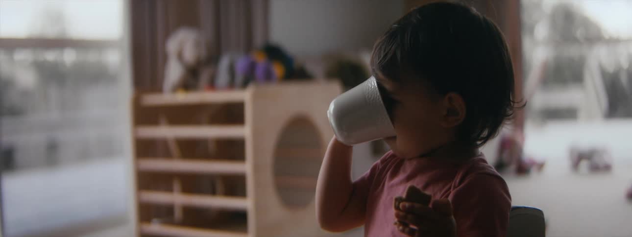 A child is drinking from a cup