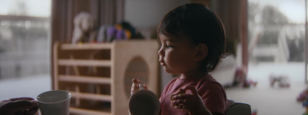A toddler is playing around inside with there parent
