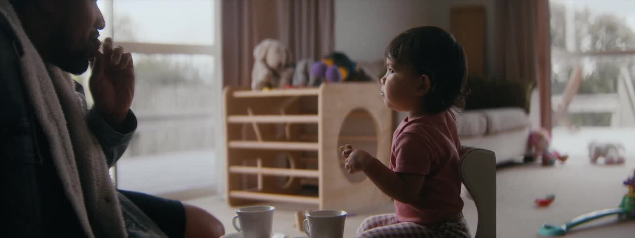 A kid and father are hanging out together in the day time