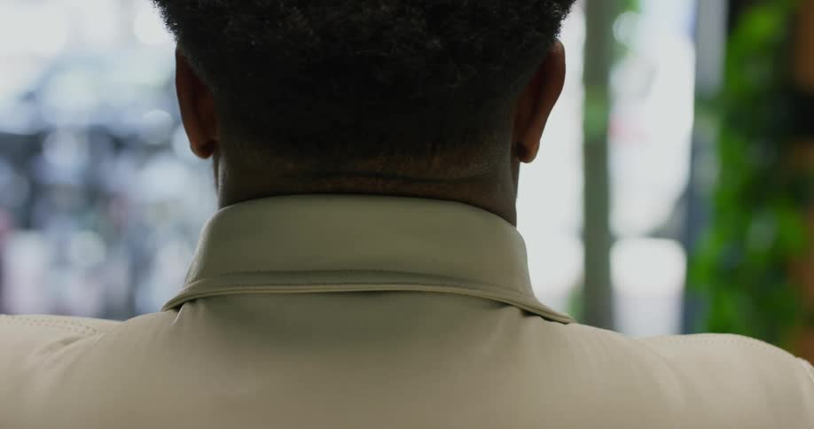 A man puts on his jacket