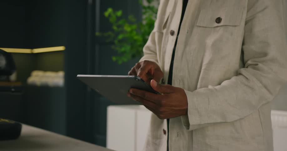 A man checks in at a spa using a tablet