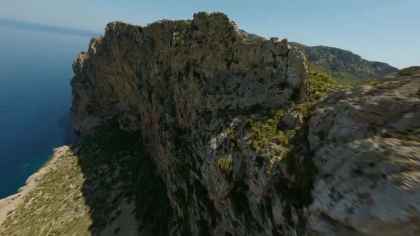 Aerial view of a mountainous area near an ocean coast is displayed