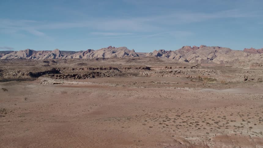 A vast arid countryside under a bright daytime sky