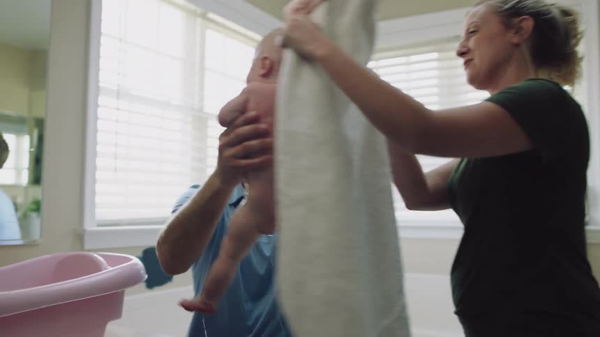 Mother and father are taking care of there baby at there home