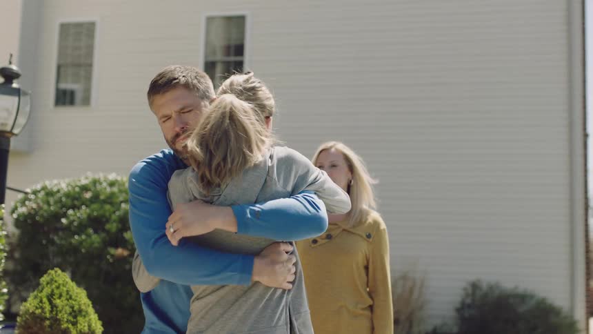 Parents hug their daughter tight as she gets ready to leave home
