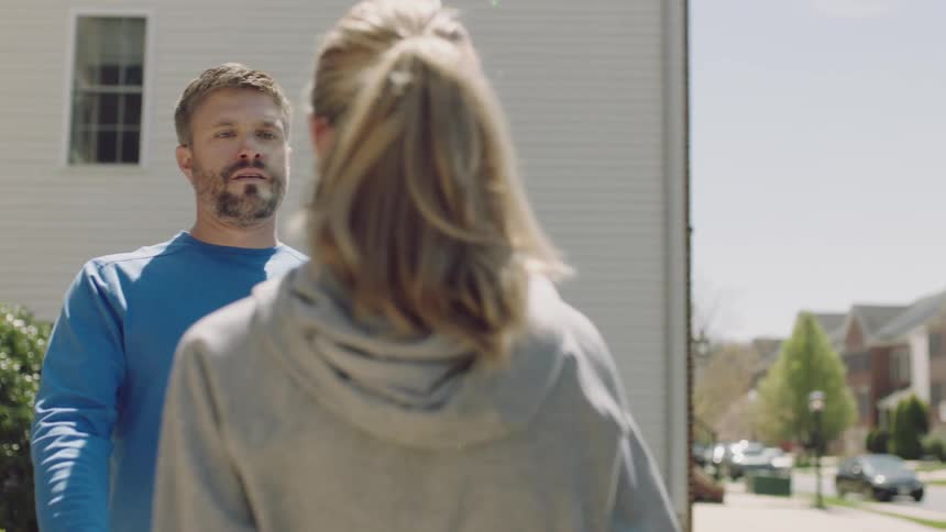 Dad looks sad as he carries a tote out for his daughter to pack into her car trunk