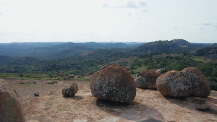 Massive boulders on mountaintop overlooking valley