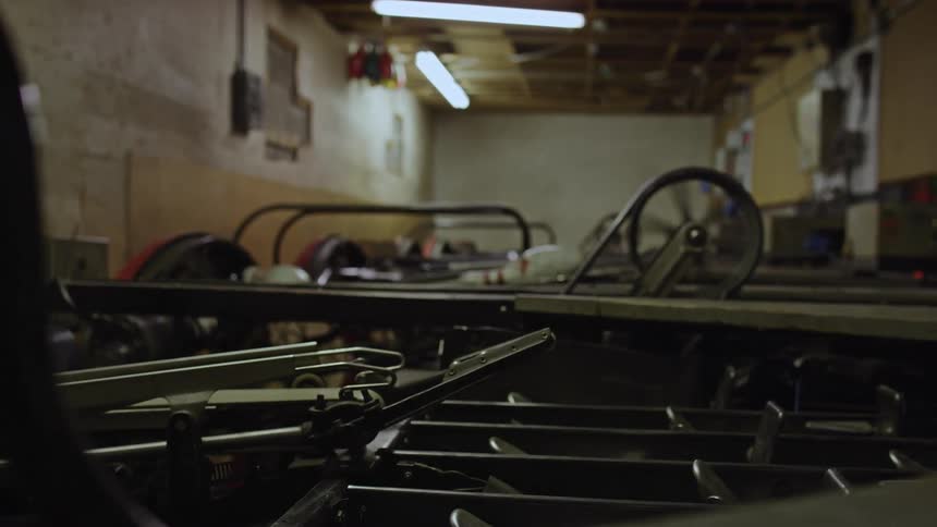 Vintage machines and conveyors move and sort bowling pins for setting up in the alley