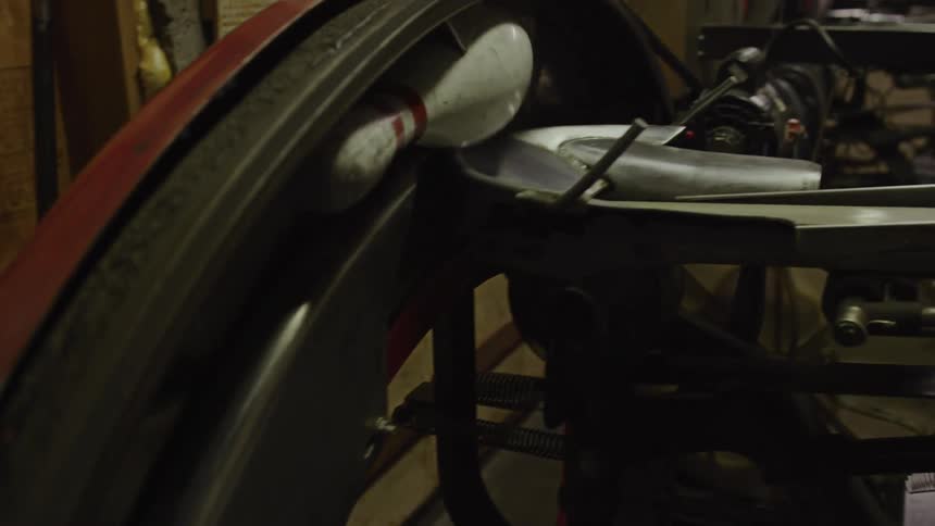 A conveyor belt in the bowling alley moves the bowling pins onto a rack