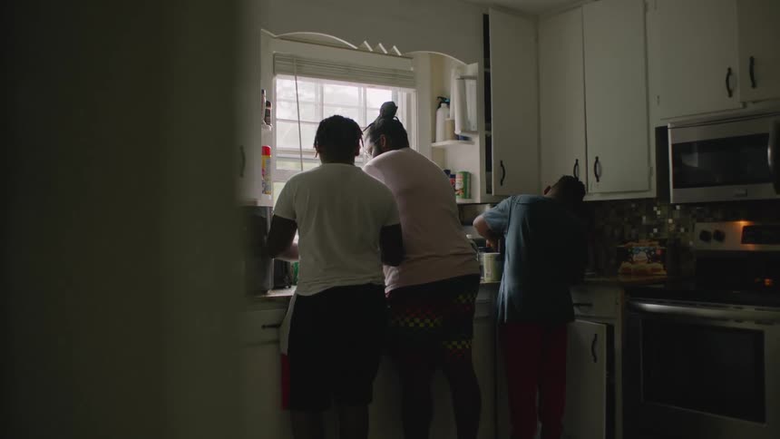Father and sons work together in kitchen