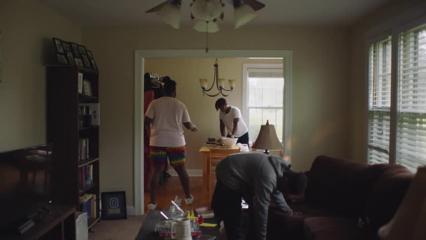 Three young black men prepare for dinner at home