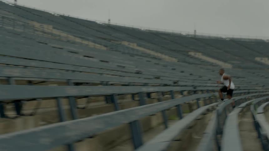 Man running up stadium steps