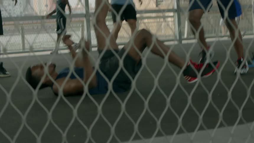 A group of guys playing basketball outdoors