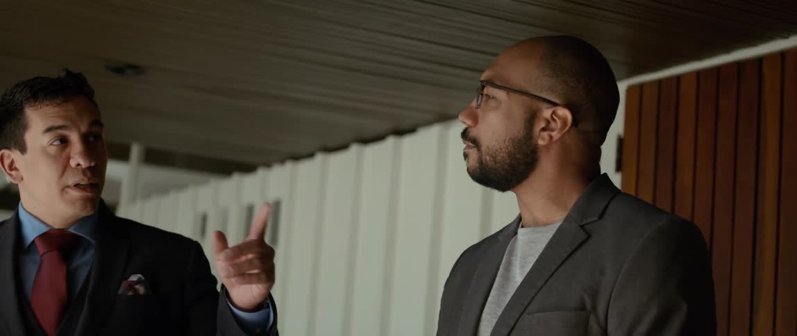 Two people in suits talking