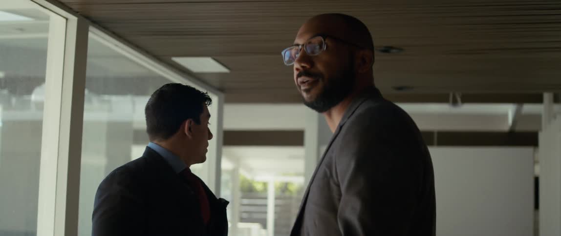 Two men talk and point out things in the home