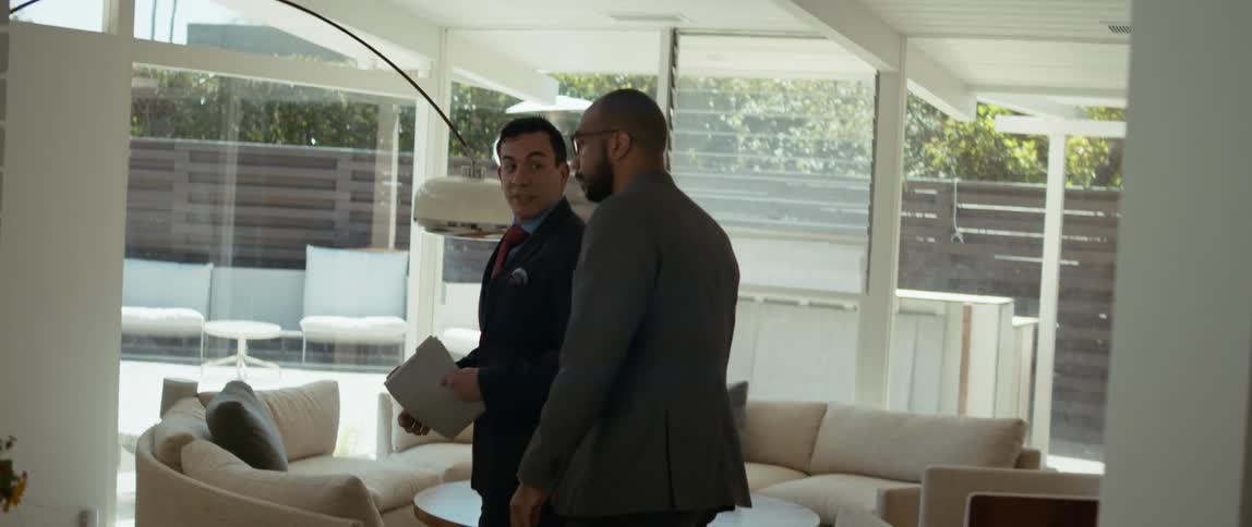 Male real estate agent showing around buyer house for sale