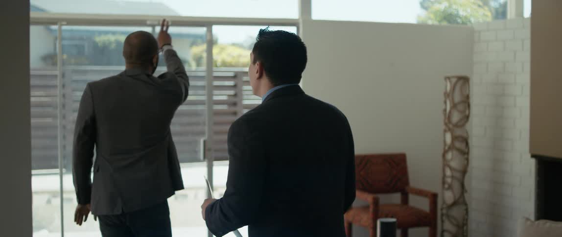 Realtor watches as customer talks about building