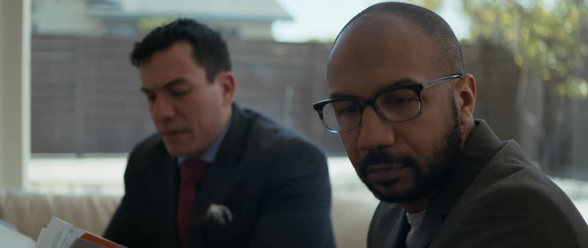 A real estate agent is reading through a folder