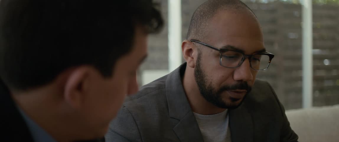A man shakes his head no as he meets with a colleague