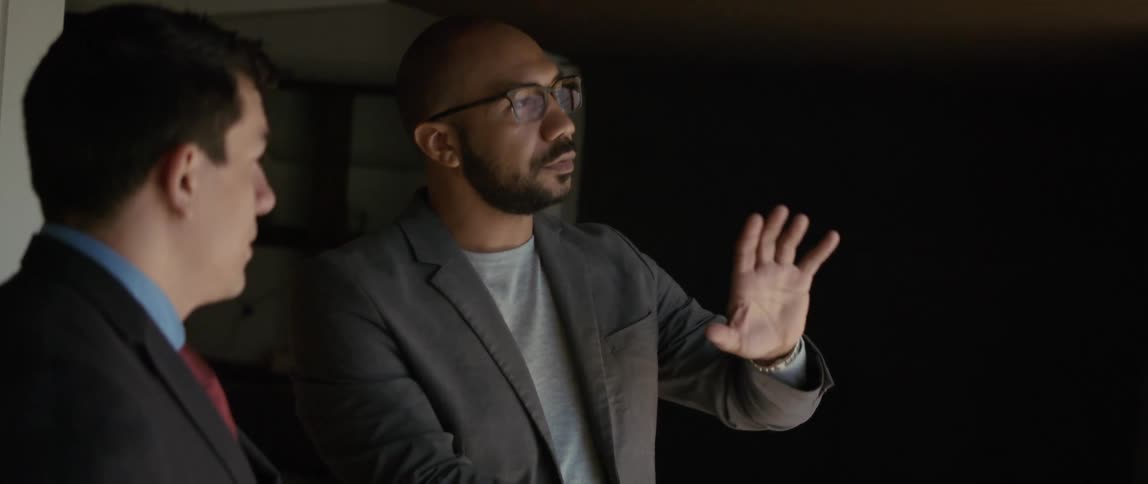 Two men are talking and one man is using his hands when he talks