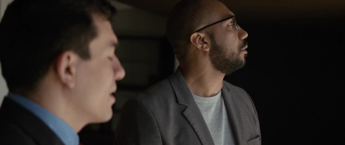 Two men talk together