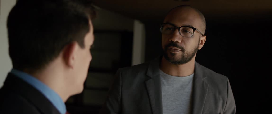 Two men are talking and one man is using his hands when he talks