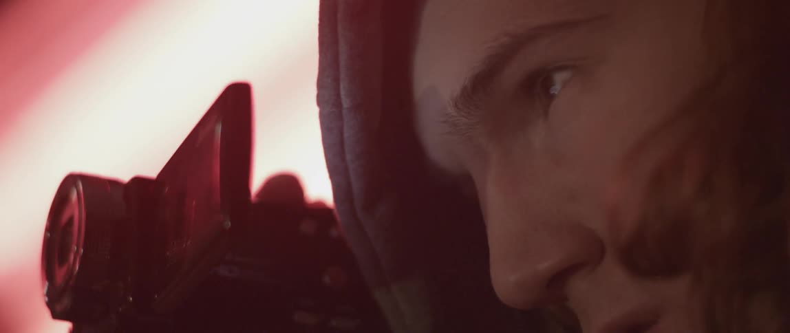 A man is filming with a camera