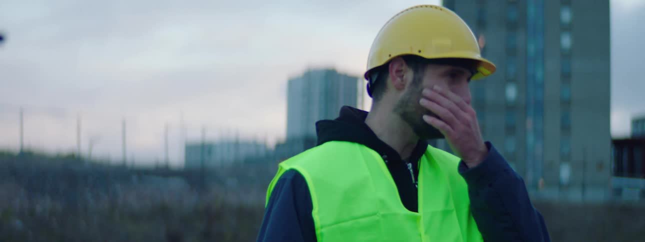 Two construction workers laugh while on a job site