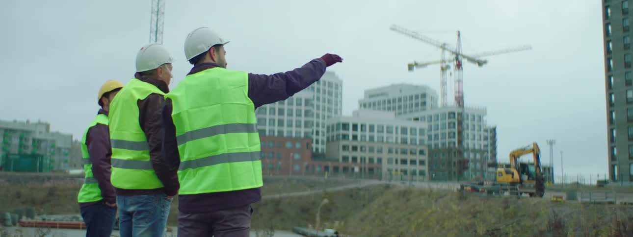 Two construction workers talk at the construction site