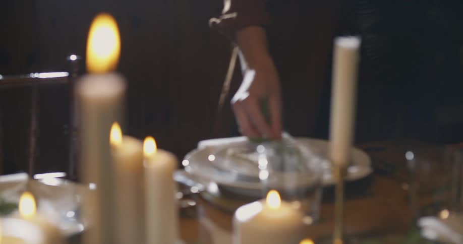 A woman is setting a table