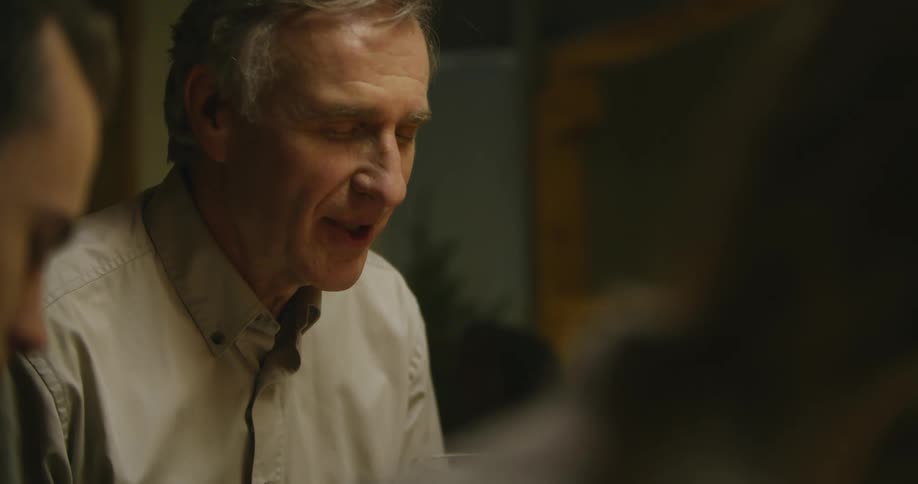 A man talks with his eyes closed