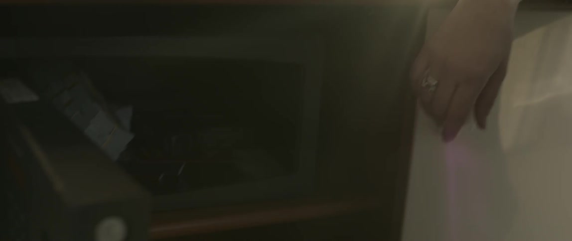 A person opens a safe