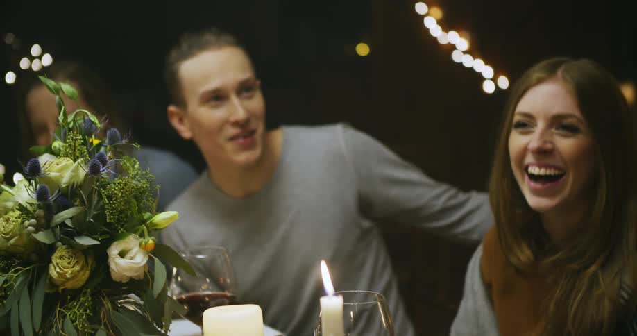 People are sitting at a table talking and laughing